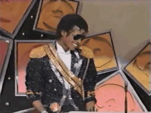 Man In Black And Gold Suit Sunglasses By Picture Wall GIF