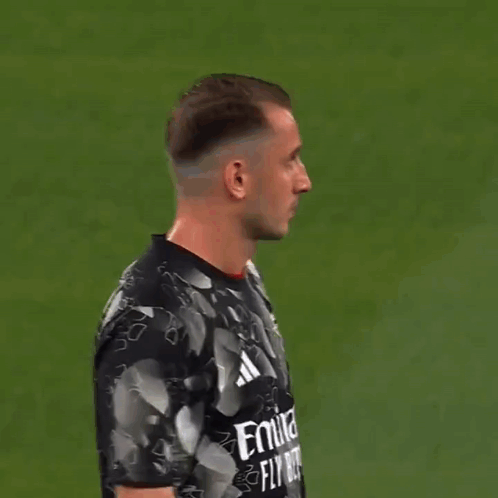 Man in Black and White Adidas Shirt Looking at Camera