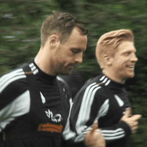 Man in Black and White Adidas Shirt Running