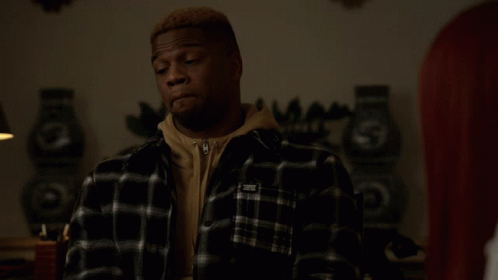 Man In Black And White Plaid Shirt With White Sticker On Sleeve GIF