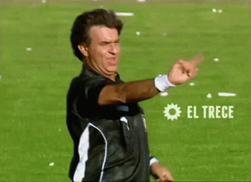 Man in Black and White Shirt Pointing at El Trece