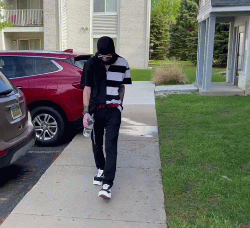Man in Black and White Striped Shirt Walking