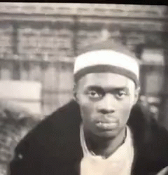 Man in Black and White with White Headband and Black Jacket