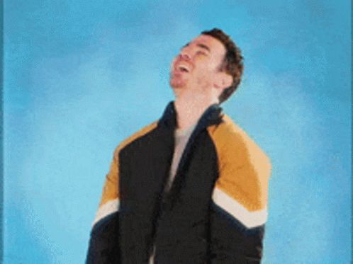 Man in Black and Yellow Jacket Making Funny Face