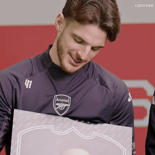 Man in Black Arsenal Shirt Holding Box