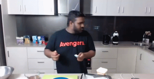 Man in Black Avengers Shirt Holding Spoon