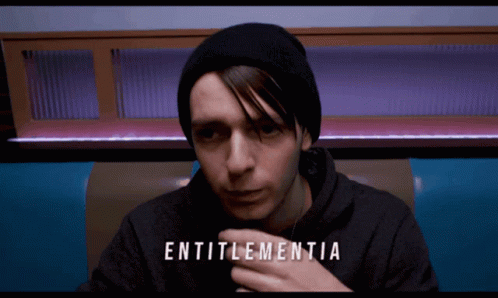 Man in Black Beanie and Black Hoodie With Word Entitlementia
