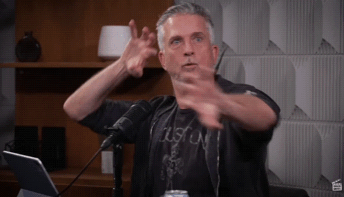 Man in Black Boston Shirt Gesturing