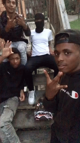 Man in Black Champion Hoodie Posing with Friends
