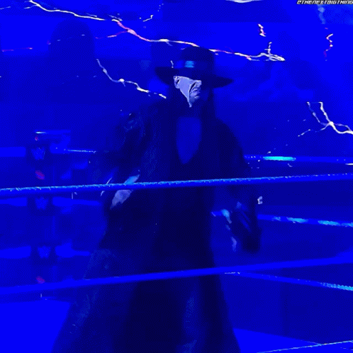 Man in Black Coat and Hat in Wrestling Ring