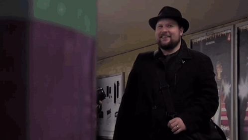 Man in Black Coat and Hat with 4 Sign