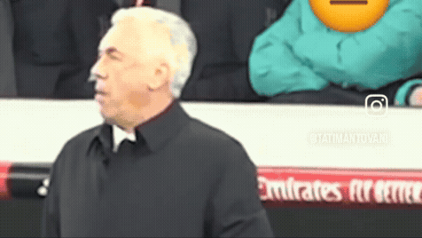 Man in Black Coat Before Emirates Banner
