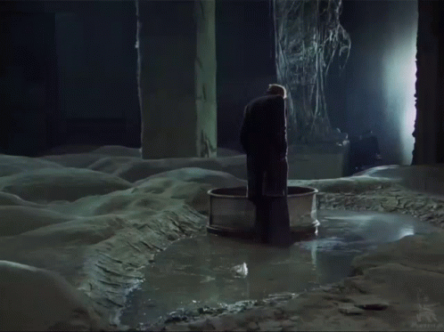 Man in Black Coat Standing in Water