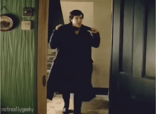 Man in Black Coat Walking Out of Doorway