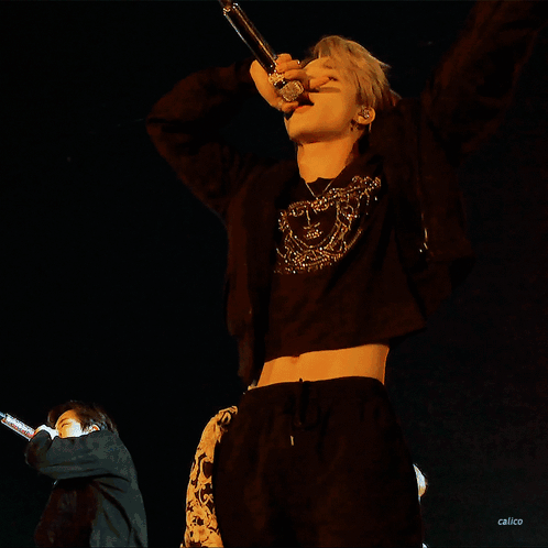 Man In Black Crop Top Singing Into Microphone GIF