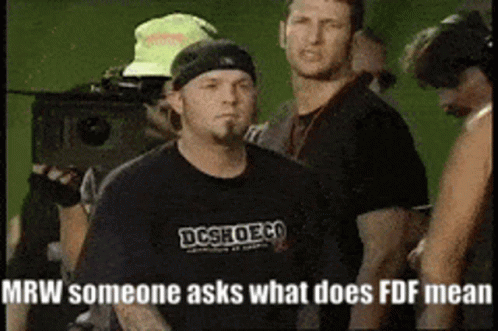 Man in Black DC Shoes Shirt in Crowd
