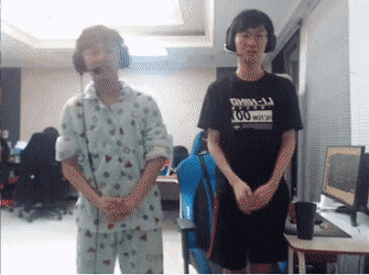 Man in Black DMM-LJ Shirt Next to Man in Pajamas