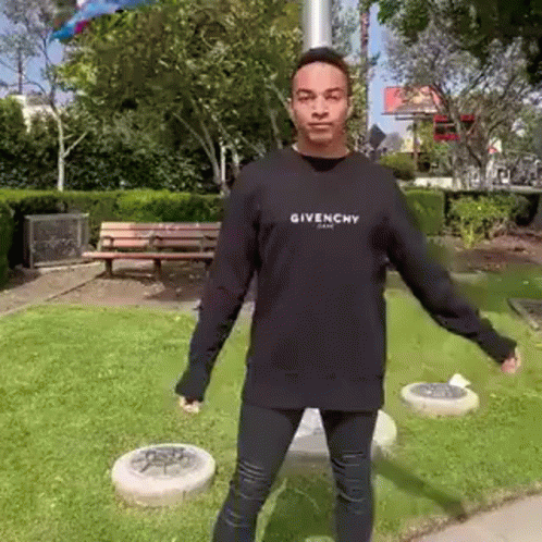 Man In Black Givenchy Sweatshirt Standing In Park GIF
