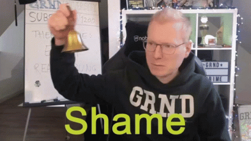 Man in Black Grand Shame Shirt Holding Bell