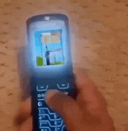 Man in Black Guess Jacket Looking at Phone