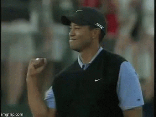 Man in Black Hat and Nike Vest Raising Fist