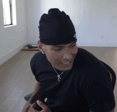 Man In Black Hat And Shirt Sitting GIF
