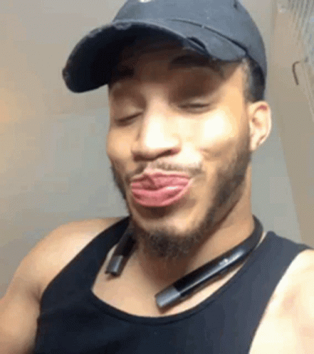Man in Black Hat and Tank Top Making Funny Face