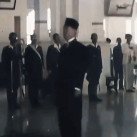 Man in Black Hat Before Group of Men