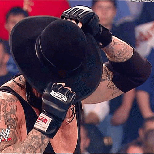 Man in Black Hat Covering Face