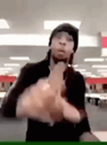 Man in Black Hat Giving Middle Finger