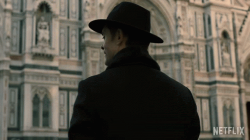Man in Black Hat in Front of Netflix Building