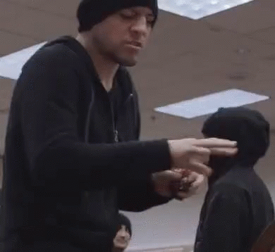 Man in Black Hat Next to Man in Black Jacket