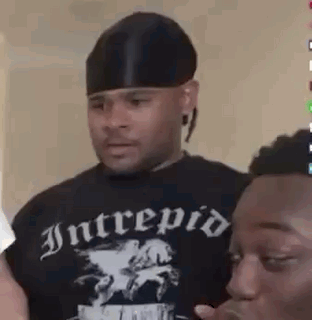Man in Black Hat Next to Man in Black Shirt