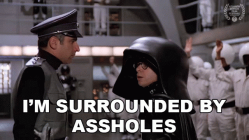 Man in Black Helmet Surrounded by Assholes