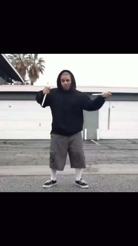Man in Black Hoodie and Grey Shorts in Front of Garage Door 29
