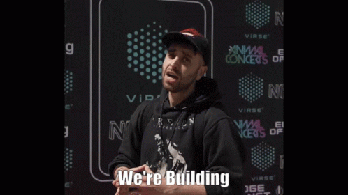 Man in Black Hoodie and Hat Says We're Building