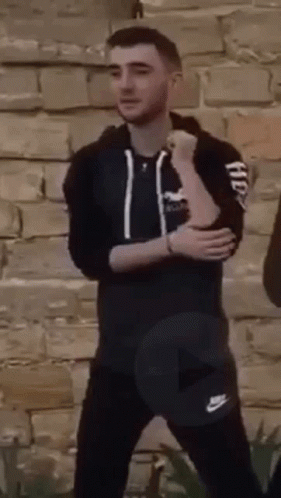 Man in Black Hoodie and Pants Arms Crossed