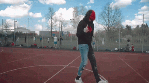Man in Black Hoodie and Red Mask Walking