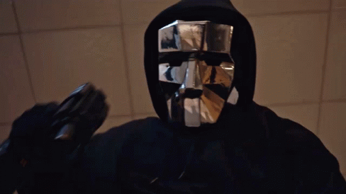 Man in Black Hoodie and Silver Mask Holding Gun