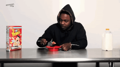 Man in Black Hoodie Eating Fruity Pebbles