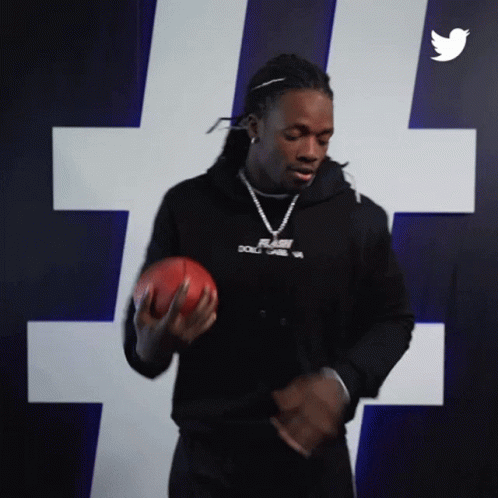 Man in Black Hoodie Holding Football