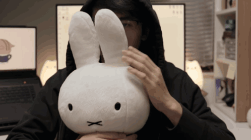 Man in Black Hoodie Holding White Rabbit