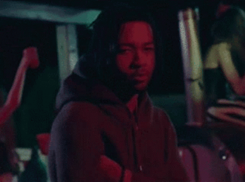 Man in Black Hoodie in Dark Room With Red Light