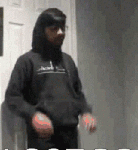 Man in Black Hoodie in Front of White Door