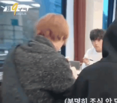Man in Black Hoodie Looking at Another Man