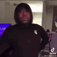 Man in Black Hoodie with Hands on Hips