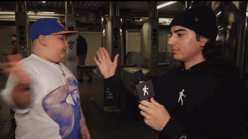 Man in Black Hoodie with Person Talking