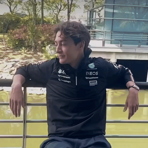 Man in Black Ineos Shirt Leaning on Railing