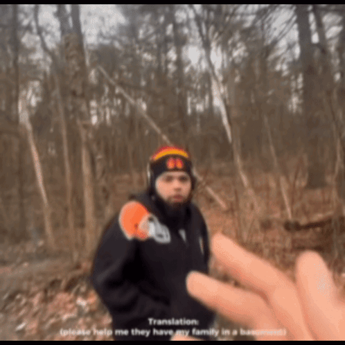 Man In Black Jacket And Beanie With Number 66 In Woods GIF