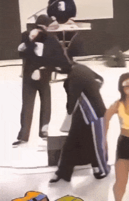 Man in Black Jacket and Blue Pants with Woman in Yellow Tank Top